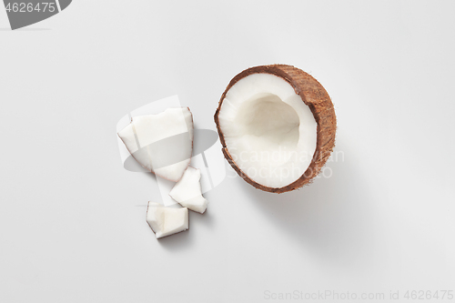 Image of Top view of fresh natural organic coconut\'s half on a light grey background.