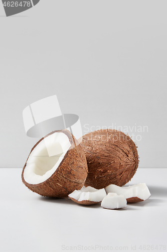 Image of Set from natural ripe coconut fruits with half and pieces on a grey background.