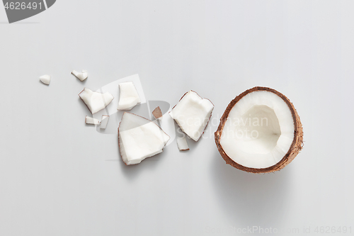 Image of Top view of fresh ripe natural organic tropical coconut fruit on a light grey background