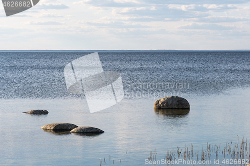 Image of Coastal view with rocks in calm water