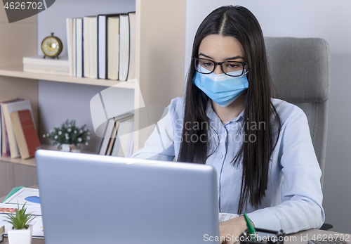 Image of Businesswoman working during the coronavirus pandemic