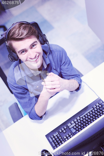 Image of male call centre operator doing his job top view