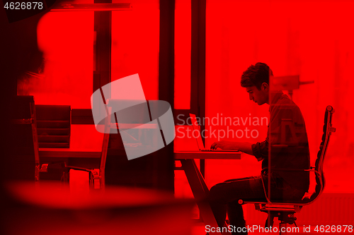 Image of businessman working using a laptop in startup office