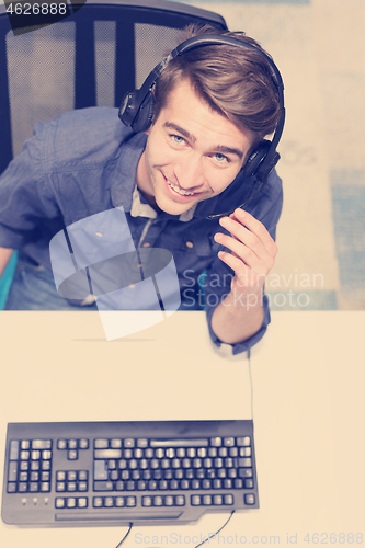 Image of male call centre operator doing his job top view