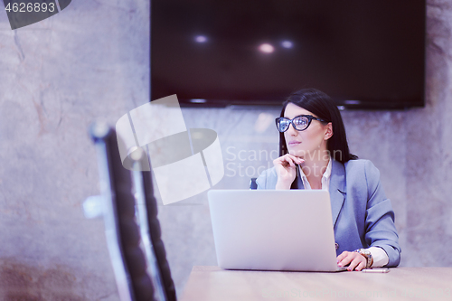Image of businesswoman using a laptop in startup office