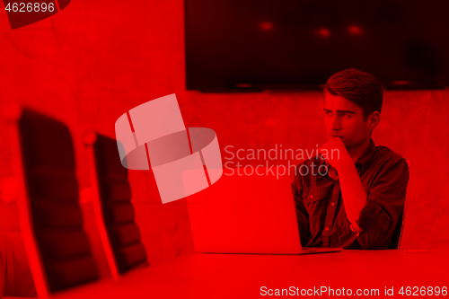 Image of businessman working using a laptop in startup office