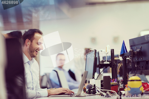 Image of businessman working using a laptop in startup office