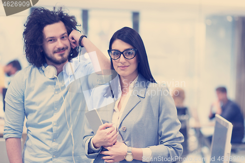 Image of Business People Working With Tablet in startup office