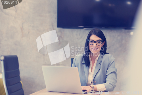 Image of businesswoman using a laptop in startup office