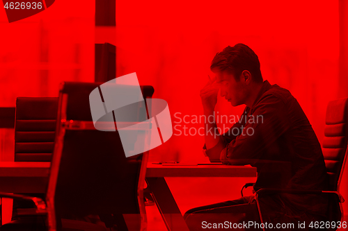 Image of young businessman relaxing at the desk