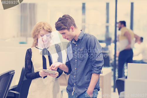 Image of Business People Working With Tablet in startup office