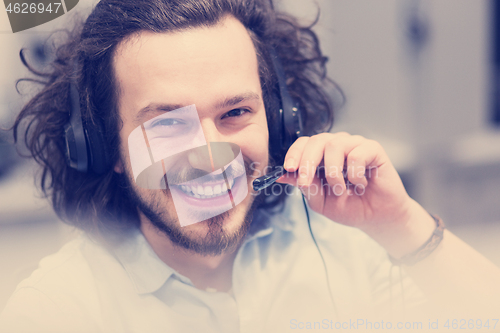 Image of male call centre operator doing his job