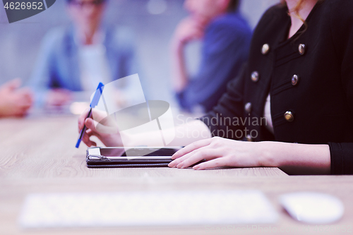 Image of businesswoman hand using pen