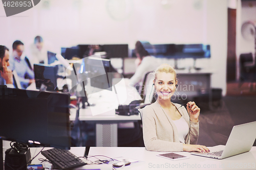 Image of businesswoman using a laptop in startup office