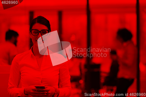 Image of Elegant Woman Using Mobile Phone in startup office building