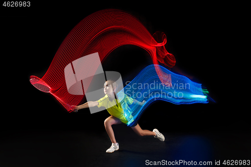 Image of one caucasian young teenager girl woman playing Badminton player on black background