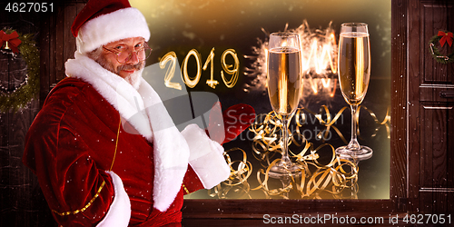 Image of The man in costume of santa claus over night city background