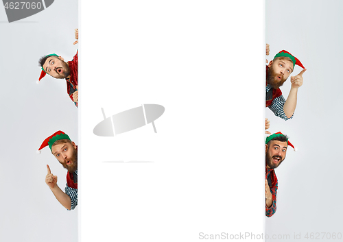 Image of friendly men dressed like a funny gnome posing on an isolated gray background