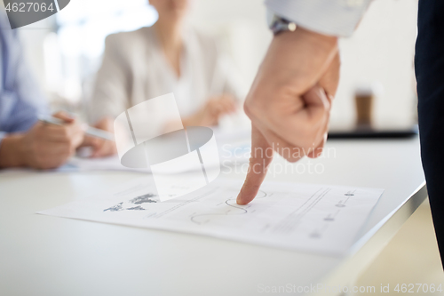 Image of close up of businessman with charts at office