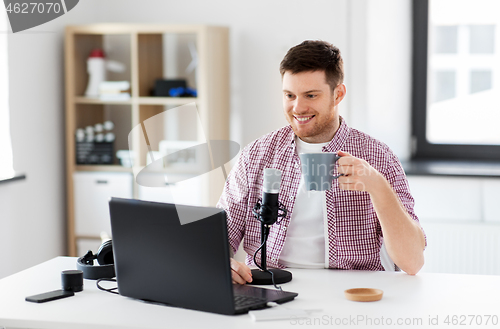 Image of blogger with laptop and microphone audio blogging