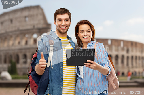 Image of happy couple of tourists with tablet computer