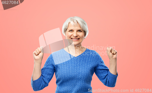 Image of portrait of happy senior woman celebrating success