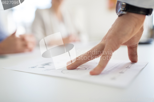 Image of close up of businessman with charts at office