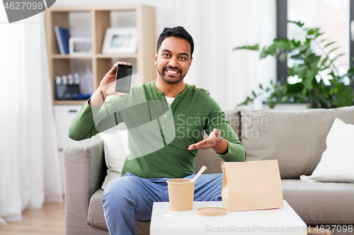 Image of indian man using smartphone for food delivery