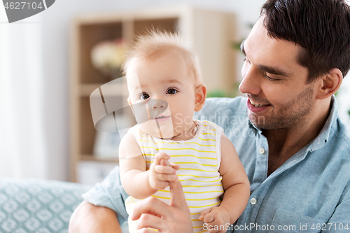 Image of father with little baby daughter at home