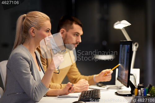 Image of designers with computer working at night office