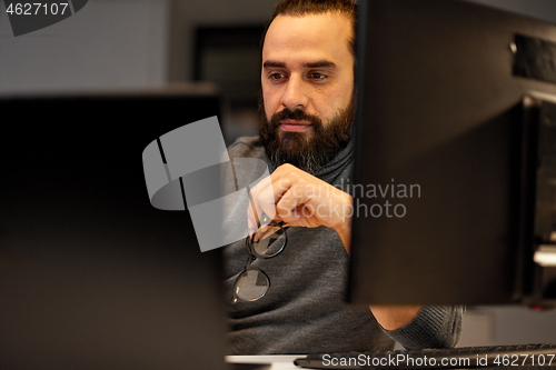 Image of close up of creative man working at night office