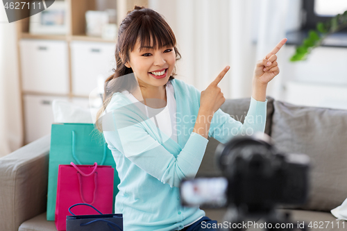 Image of female blogger making video blog about shopping