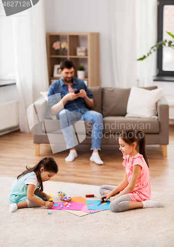 Image of happy sisters doing arts and crafts at home