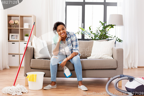 Image of african woman or housewife after cleaning at home