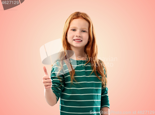 Image of smiling red haired girl showing thumbs up