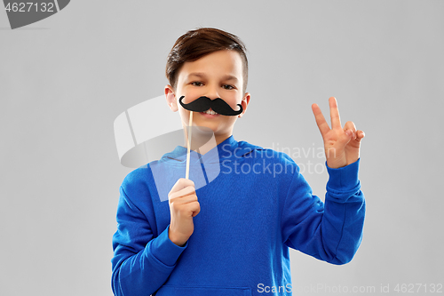 Image of smiling boy in blue hoodie with black moustaches