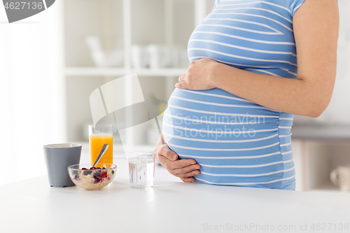 Image of close up of pregnant woman touching her belly