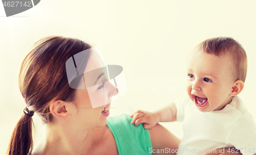 Image of happy young mother with little baby at home