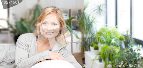 Image of happy middle aged woman at home