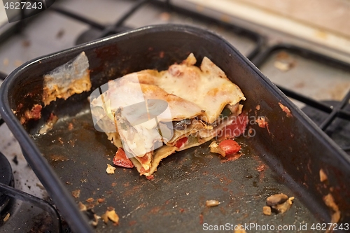 Image of Lasagna leftover in a dirty kitchen