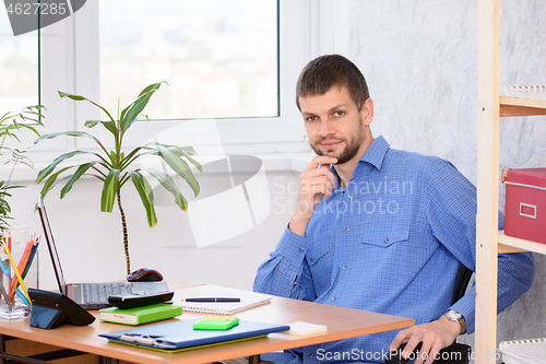 Image of Confident specialist at the workplace in the office