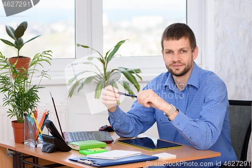 Image of Portrait of an office specialist at a desk in an office