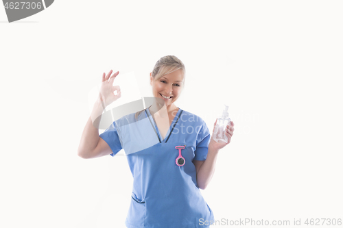 Image of Nurse recommending use of hand sanitizer alcohol rub for hand hygiene