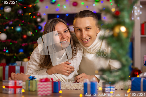 Image of Christmas happy girl and young man smile, look in the frame