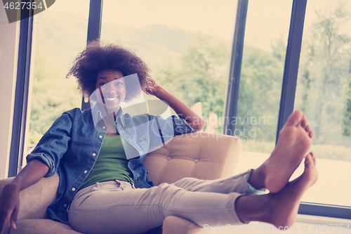 Image of black women at home in the chair