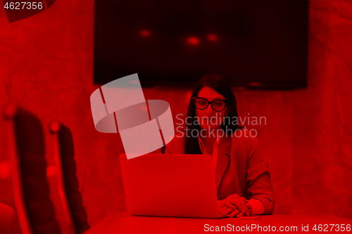 Image of businesswoman using a laptop in startup office