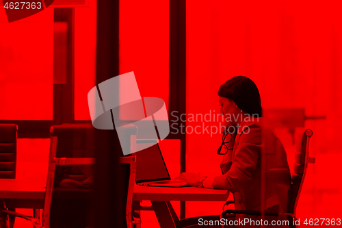 Image of businesswoman using a laptop in startup office