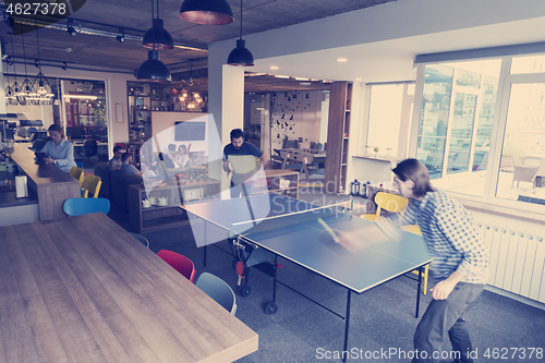 Image of playing ping pong tennis at creative office space