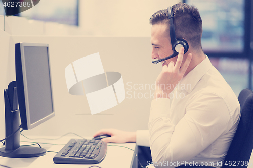 Image of male call centre operator doing his job