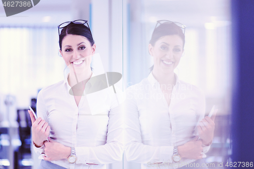 Image of Business Woman Using Digital Tablet in front of startup Office